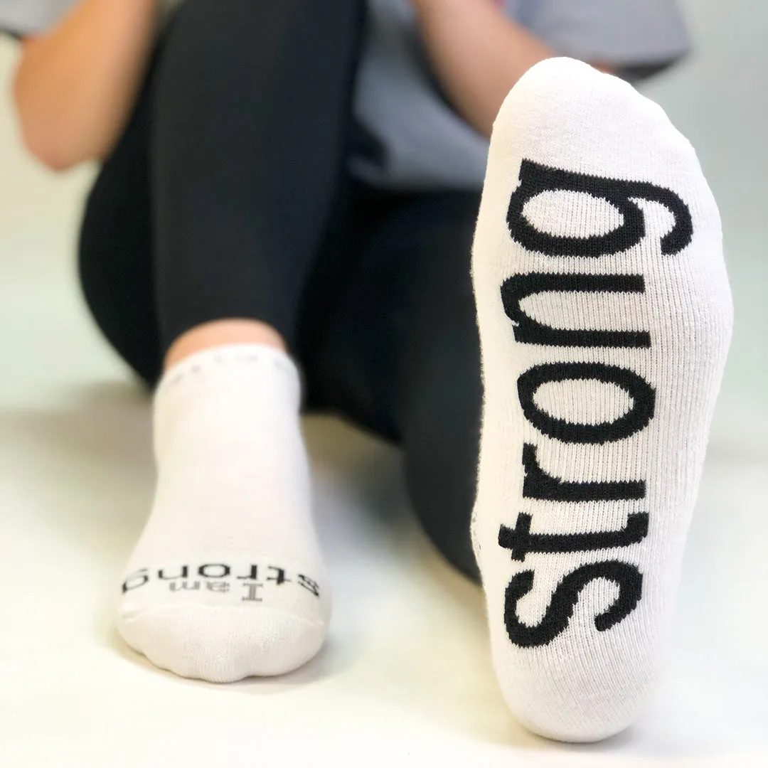 I am strong™ white low-cut socks with black words